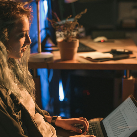 A woman works at a laptop